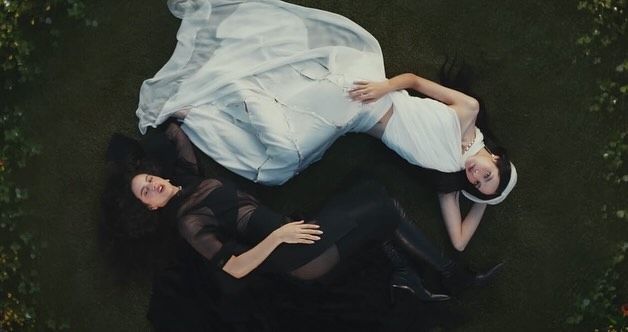 gaya kece lisa 'blackpink' dan  rosalía di music video 'new woman', 1. Lisa mengawali video musiknya dengan penampilan fierce. Memancarkan aura dark feminine, Ia pakai mantel hitam yang dikenakan di atas bra berkilauan dan celana pendek mikro yang serasi, dilengkapi dengan kalung hati metalik dan sepatu boots setinggi lutut., 2. Tampil dengan gaya a la gilded girl, Lisa pakai atasan metalik dan rok mini warna gold yang serasi. Suede boots warna nude dari Maison Margiela melengkapi gayanya., 3. Rosalía dengan gaya khasnya berikan sentuhan modern pada outfit yang terinspirasi dari flamenco. Ia mengenakan dress merah dengan potongan asimetris dengan garis leher rendah dipadukan dengan ankle boots merah. Warna merah yang berani menciptakan siluet dramatis yang kuat dan feminin., 4. Gaya Rosalía selanjutnya pakai bodysuit warna putih dengan motif floral merah dipadukan dengan heels hitam yang memancarkan nuansa vintage., 5. Dalam salah satu adegan, Lisa tampil fierce mengenakan pakaian bulu-bulu hitam, yang dipadukan dengan riasan mata gelap dan tatanan rambut sleek. , 6. Lisa bergaya edgy dengan atasan korset, celana kargo low-rise dan belt putih bergaya Y2K. Di adegan lainnya Ia melengkapi penampilannya dengan mantel bulu yang terinspirasi dari gaya Mob Wife yang vintage sekaligus berani., 7. Seperti Yin&amp;Yang, Lisa dan Rosalía mengenakan outfit hitam putih dengan dress berbahan sheer yang flowy., 8. Dalam adegan terakhir, Rosalía pakai mantel bertekstur warna pink yang dipadukan dengan kacamata biru reflektifnya yang memberi sentuhan modern. Di sampingnya, Lisa tampil kontras dengan outfit yang lebih edgy, mengenakan jaket kulit hitam dan putih dengan kacamata bergaya futuristik.