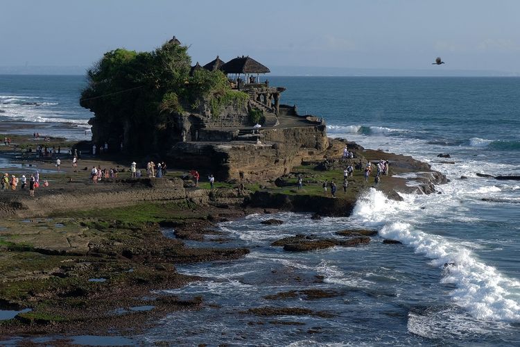 Wisatawan mengunjungi objek wisata Tanah Lot pada pemberlakuan pembatasan kegiatan masyarakat (PPKM) level 3 di Tabanan, Bali, Sabtu (9/10/2021). Objek wisata di Pulau Dewata tersebut mulai ramai dikunjungi wisatawan domestik setelah kasus COVID-19 melandai dan menjelang dibukanya kembali Pariwisata Bali untuk wisatawan mancanegara pada 14 Oktober 2021 mendatang. ANTARA FOTO/Nyoman Hendra Wibowo/nz 
